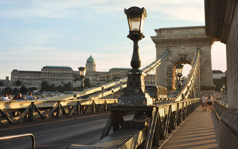 People walking across bridge in Budapest