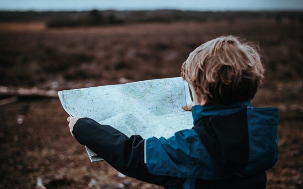 Little boy reading map