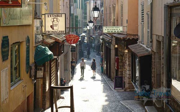 Group walking up a quiet street in France