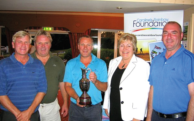 Marjorie Marks-Stuttle posing with golf trophy