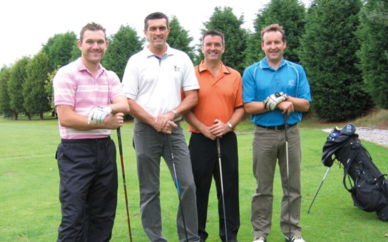 Men posing with golf clubs