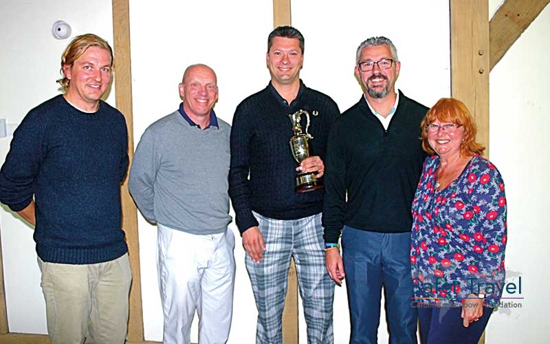 Richard Stuttle and others posing with golf trophy