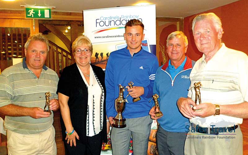 Marjorie Marks-Stuttle and others posing with golf trophies