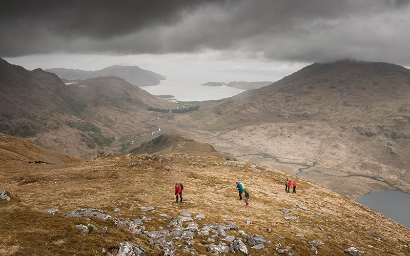 Group hiking up a hill