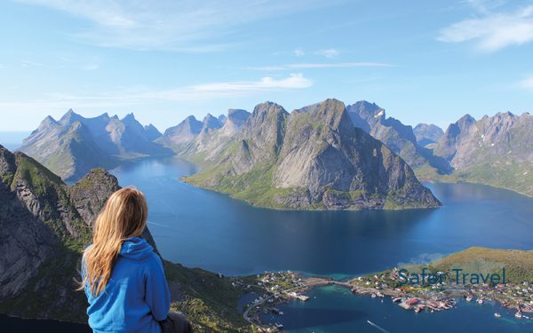 Woman looking out over mountains and water