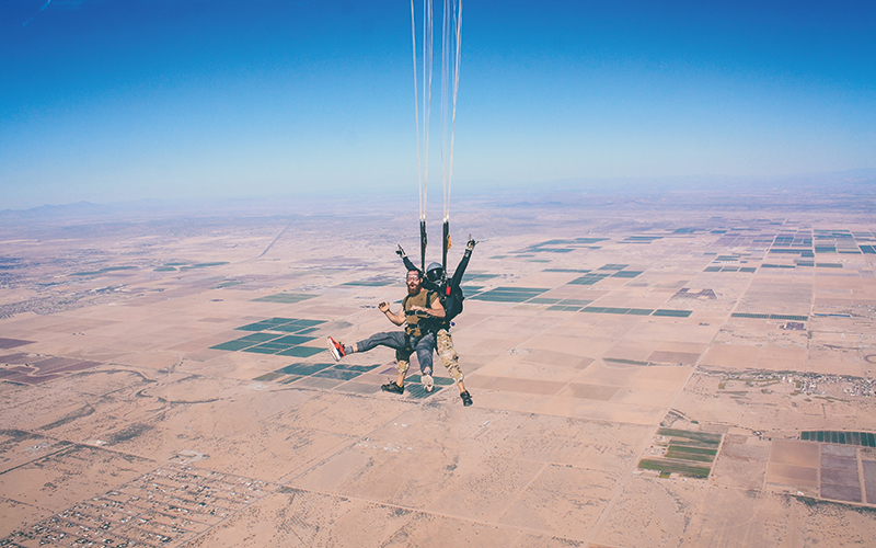 Two people posing during skydiving