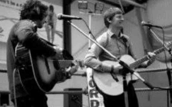 Two men playing guitars