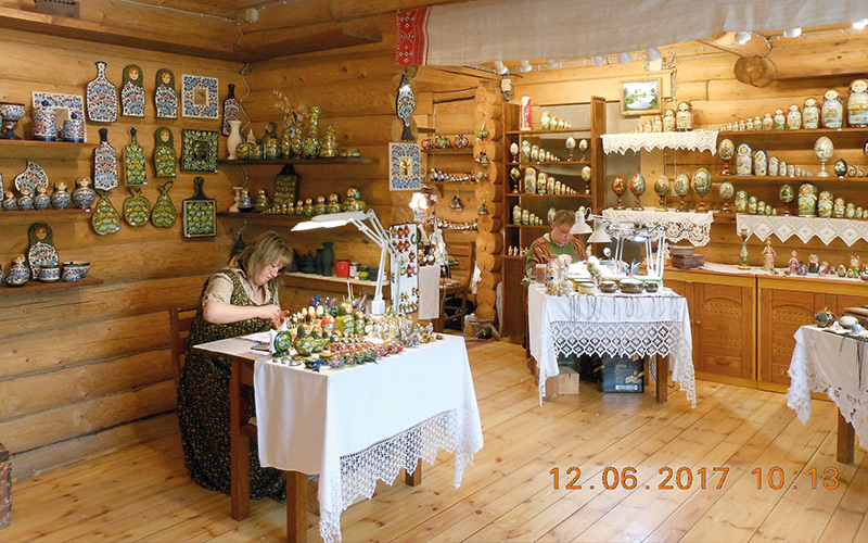 Woman sat making something in shop