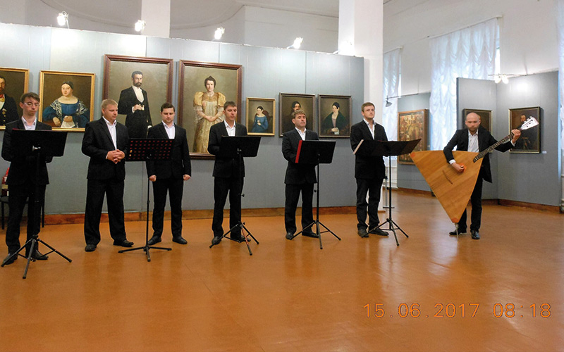 Choir singing and man playing traditional instrument