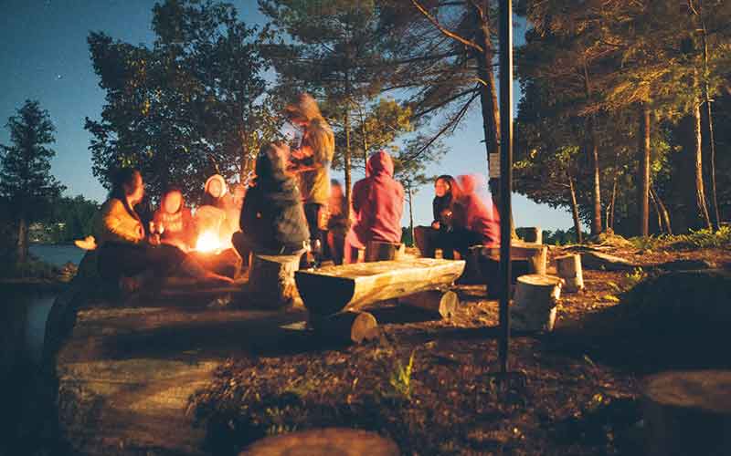 People sat around a campfire