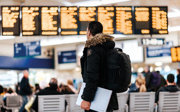 Man looking at train times