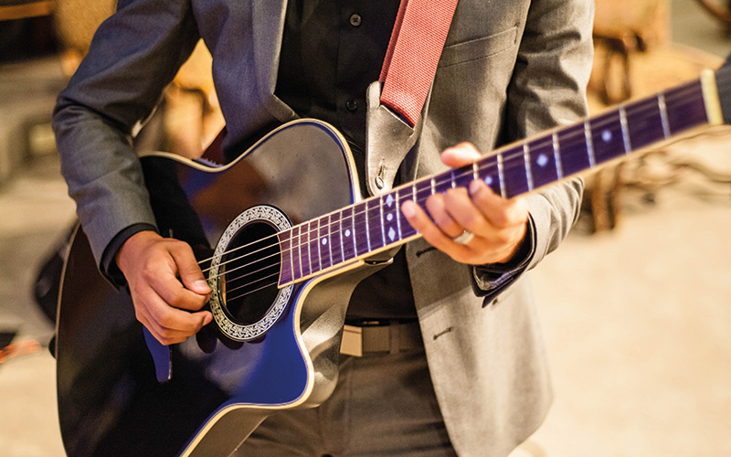 Man playing purple guitar