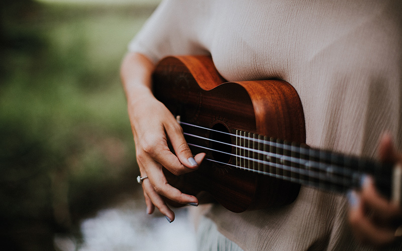 Person playing ukulele