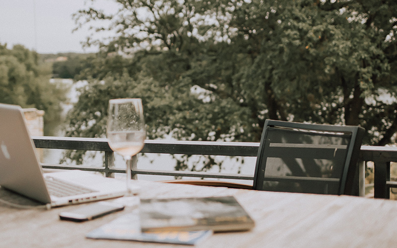 Laptop and wine on table