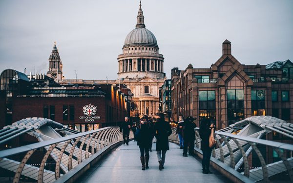 People walking along bridge in London