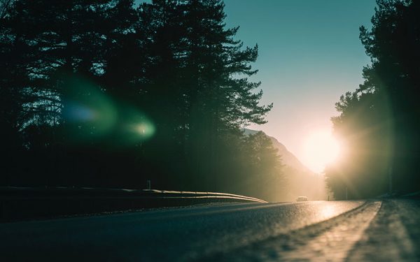 Windy road with car on