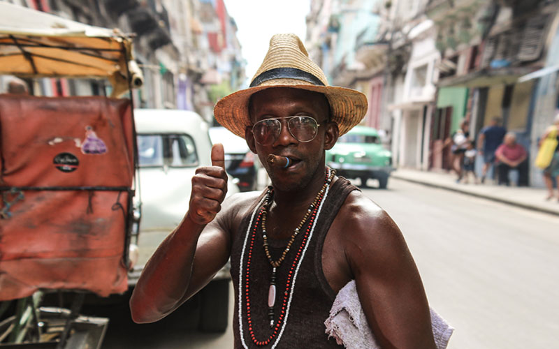Man smoking cigar gibing thumbs up