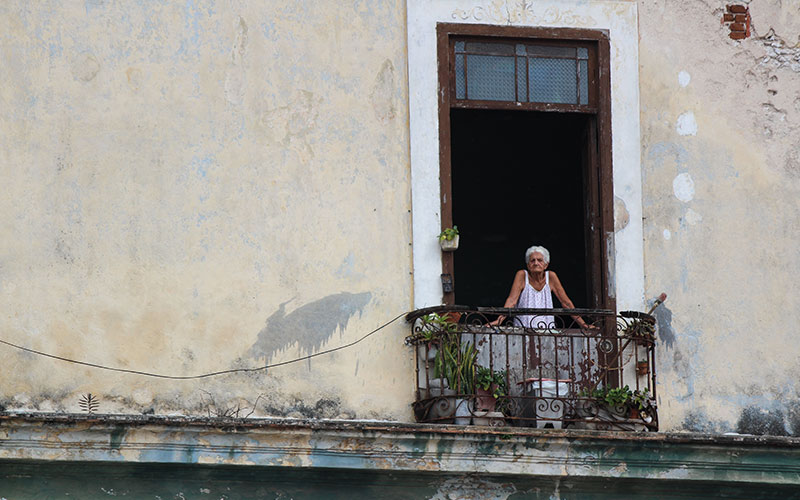 Old woman looking out of window