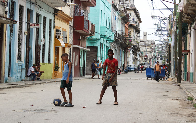 Children playing football in street