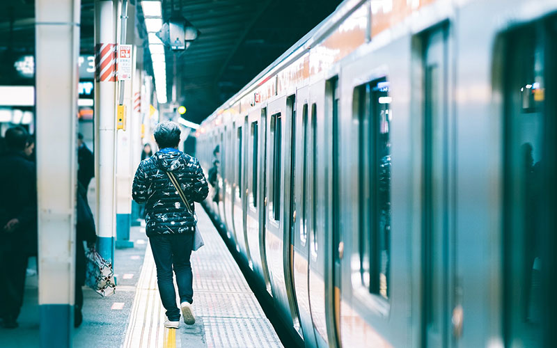 Man walking past train