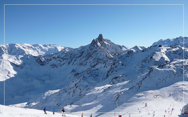 Snowboarders going down Meribel slopes