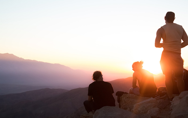 Friends enjoying the sunset views on holiday