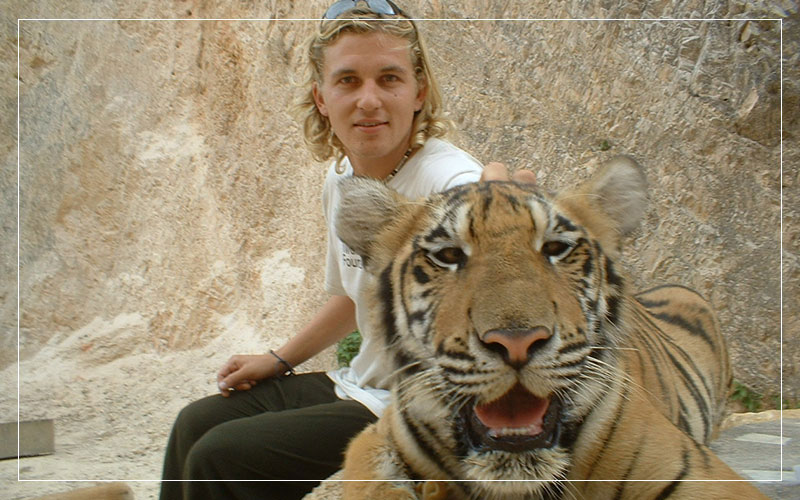 Richard Stuttle petting a tiger