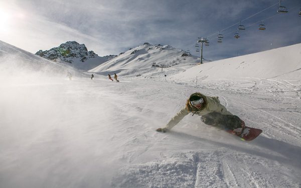 Man snowboarding down mountain